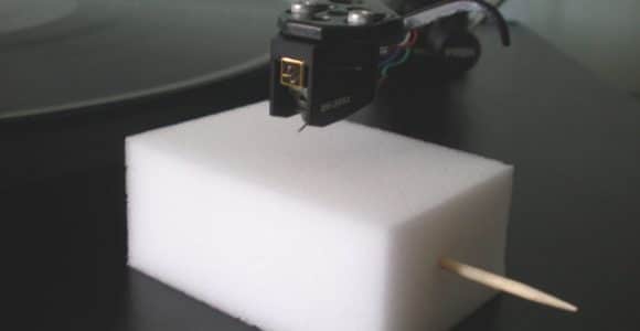 Stylus being cleaned on a melamine foam block